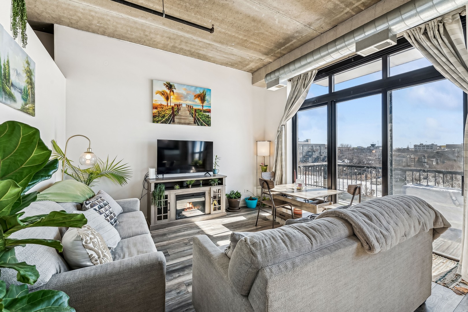 833 West 15th Place, Unit 511 Chicago, IL 60608 - Photo 6 of 16 a living room with furniture large windows and a flat screen tv