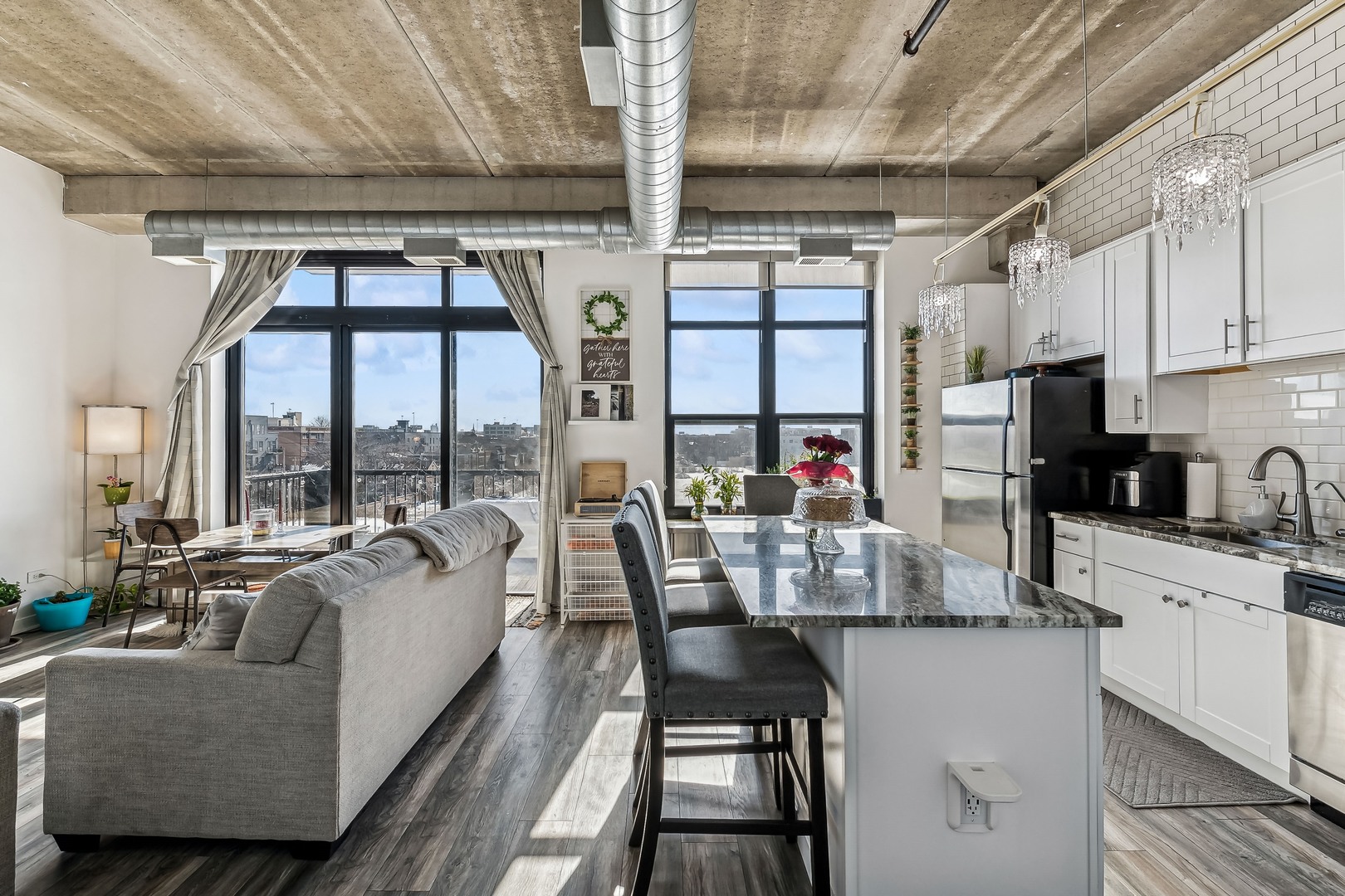 833 West 15th Place, Unit 511 Chicago, IL 60608 - Photo 9 of 16 a dining room with furniture a chandelier and fireplace