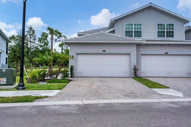 a view of a house with a yard and garage