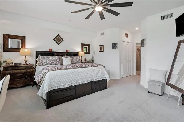 a bedroom with a bed and a lamp