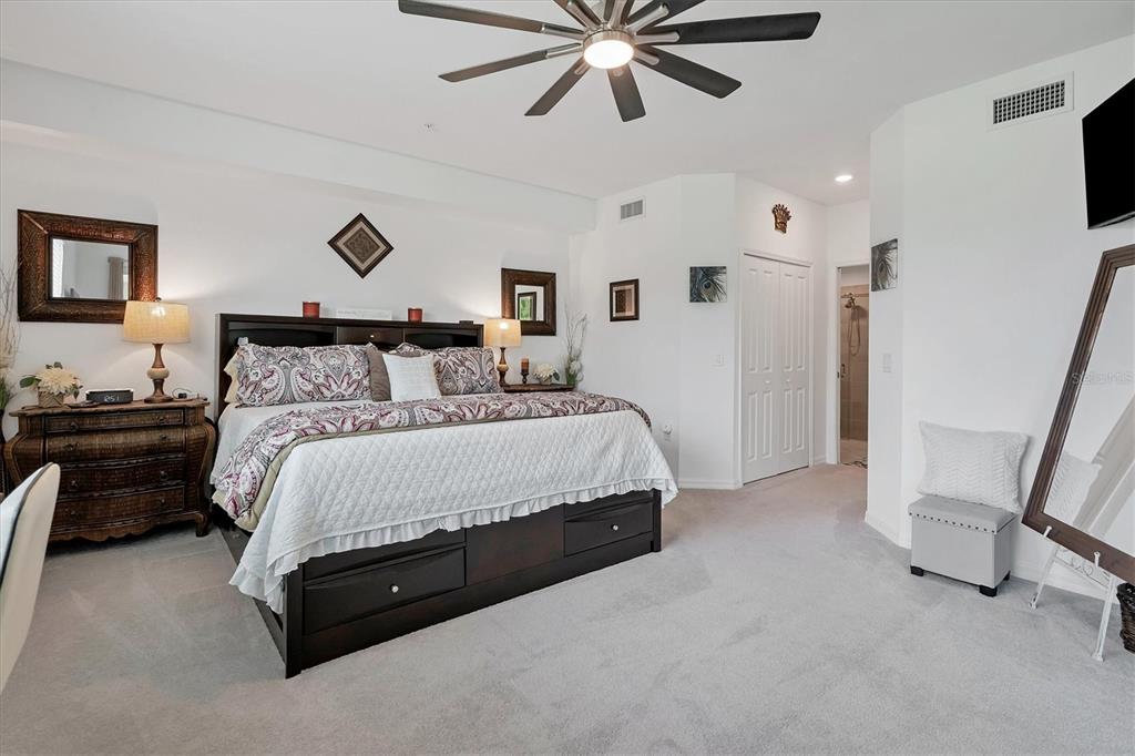 14149 Poppy Field Loop, Unit 6011 Punta Gorda, FL 33955 - Photo 14 of 63 a bedroom with a bed and a chandelier