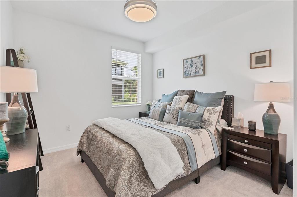 14149 Poppy Field Loop, Unit 6011 Punta Gorda, FL 33955 - Photo 19 of 63 a bedroom with a bed and a lamp