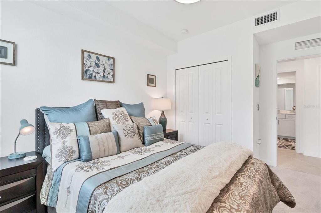 14149 Poppy Field Loop, Unit 6011 Punta Gorda, FL 33955 - Photo 20 of 63 a bedroom with bed and painting on the wall