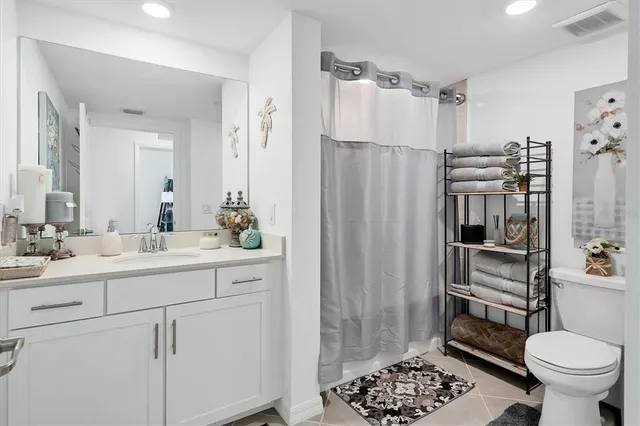 a view of a city from a balcony with furniture