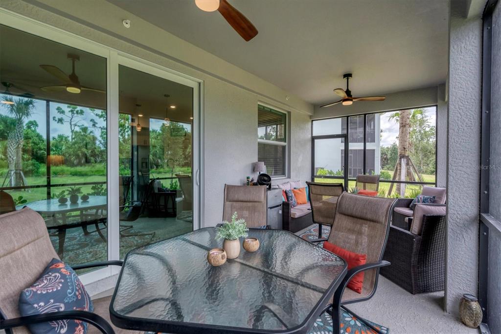 14149 Poppy Field Loop, Unit 6011 Punta Gorda, FL 33955 - Photo 25 of 63 a living room with furniture and a floor to ceiling window