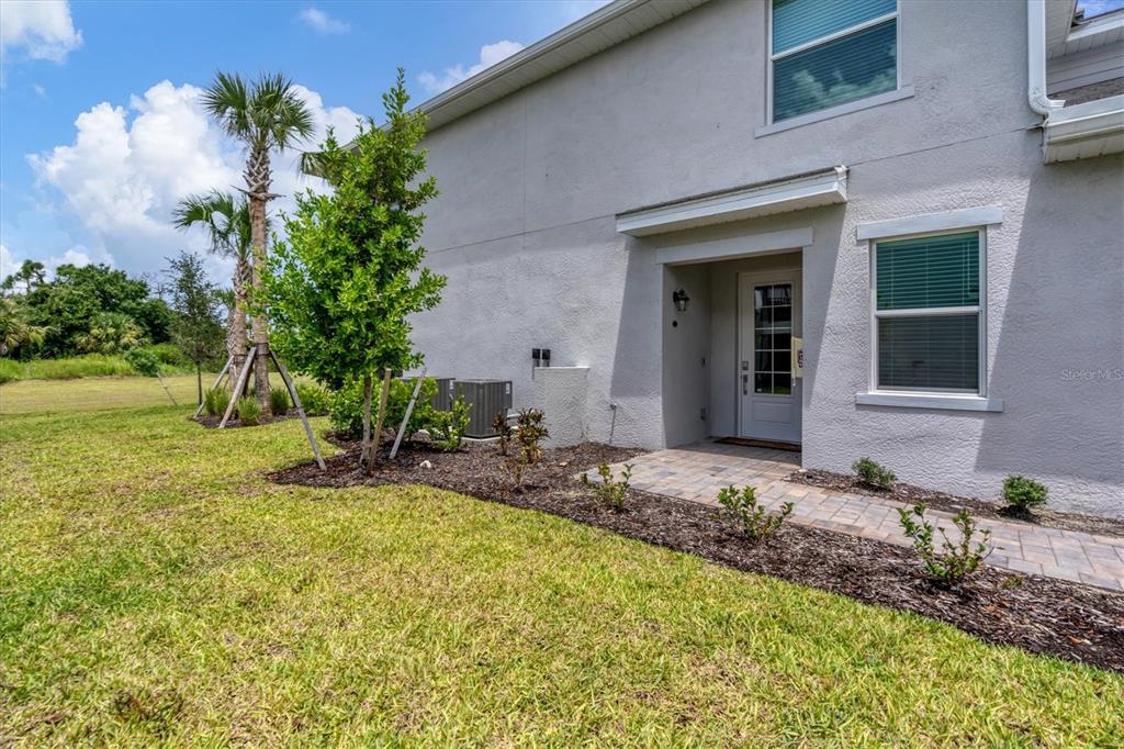 14149 Poppy Field Loop, Unit 6011 Punta Gorda, FL 33955 - Photo 30 of 63 a front view of a house with a yard