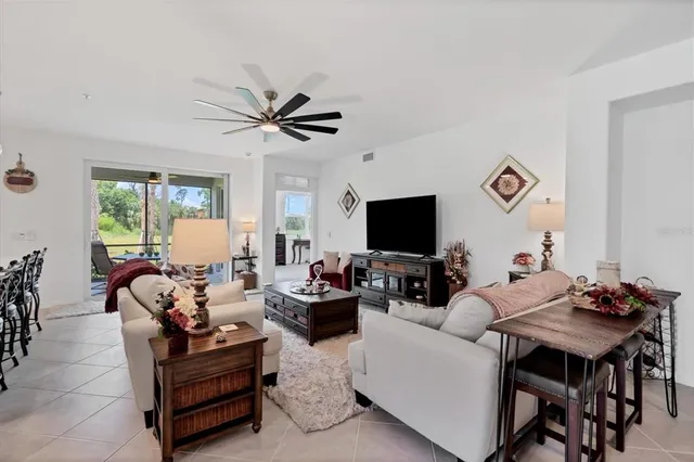 a living room with furniture a flat screen tv and a window