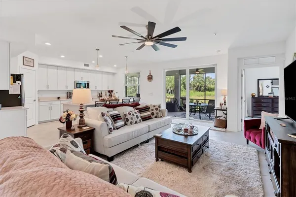 a living room with furniture ceiling fan and a rug