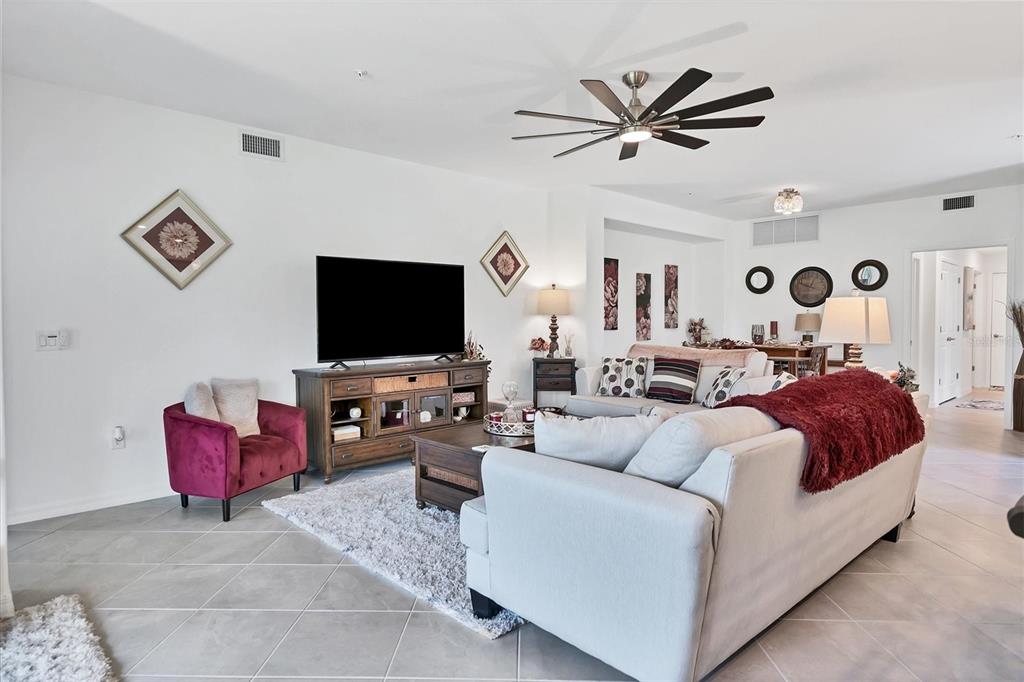14149 Poppy Field Loop, Unit 6011 Punta Gorda, FL 33955 - Photo 5 of 63 a living room with furniture and a flat screen tv