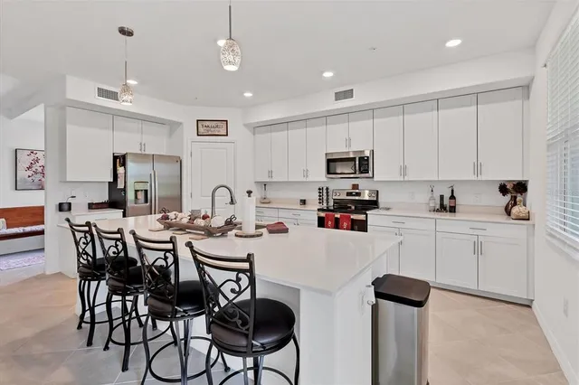 a kitchen with white cabinets and white appliances