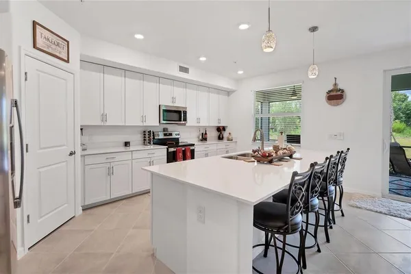 a view of a dining room and livingroom with furniture wooden floor and a rug