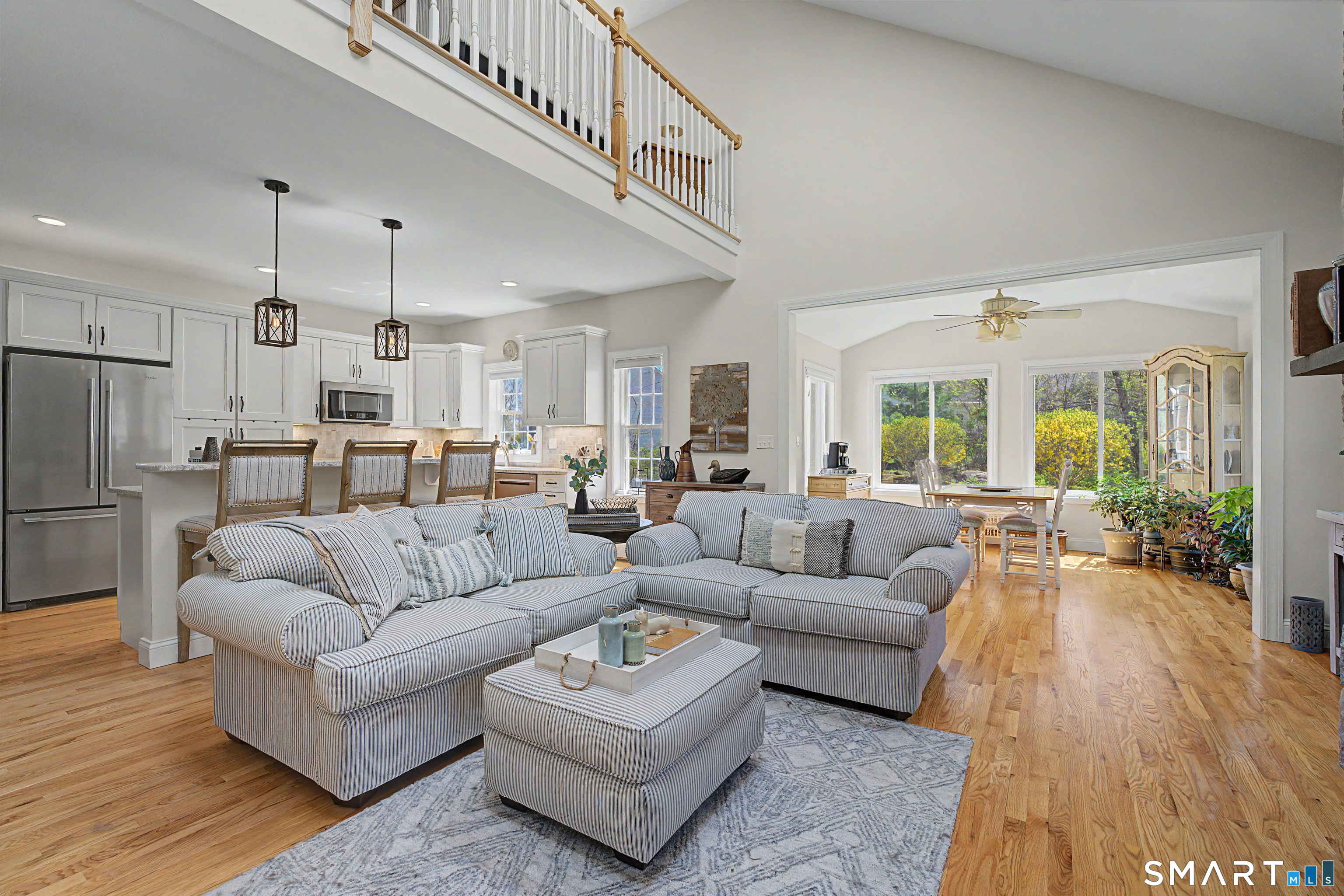 211 Meadowbrook Road, Unit 211 Oxford, CT 06478 - Photo 7 of 38 Seamless open-concept design connects the family room, kitchen, and dining area, enhanced by soaring ceilings and abundant natural light.