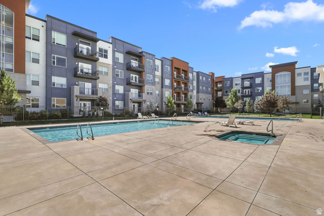 8264 South Resaca Drive, Unit K3 Sandy, UT 84070 - Photo 29 of 30 Community courtyard featuring two swimming pools and an integrated hot tub