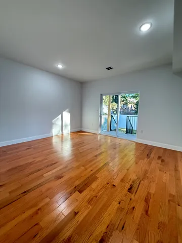a view of balcony with wooden floor