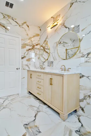 a spacious bathroom with a double vanity sink a mirror and a shower