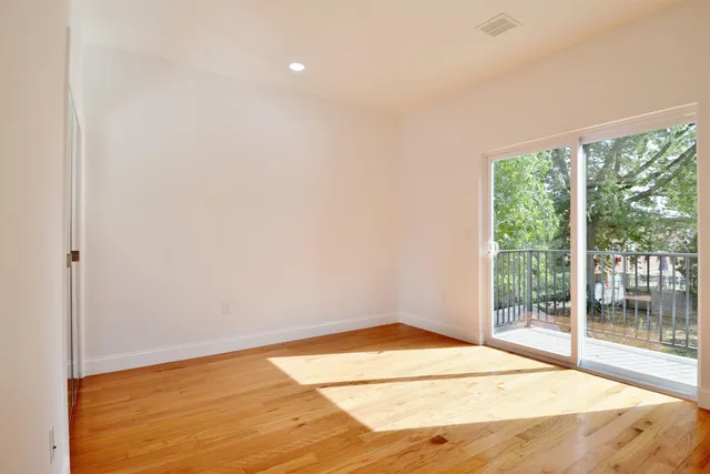 a bedroom with a bed a mirror and dresser