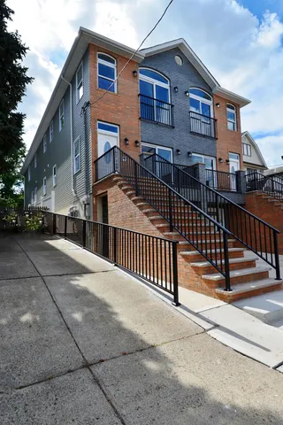 a view of a house with wooden fence