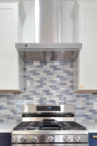 a bathroom with a granite countertop sink mirror and bathtub