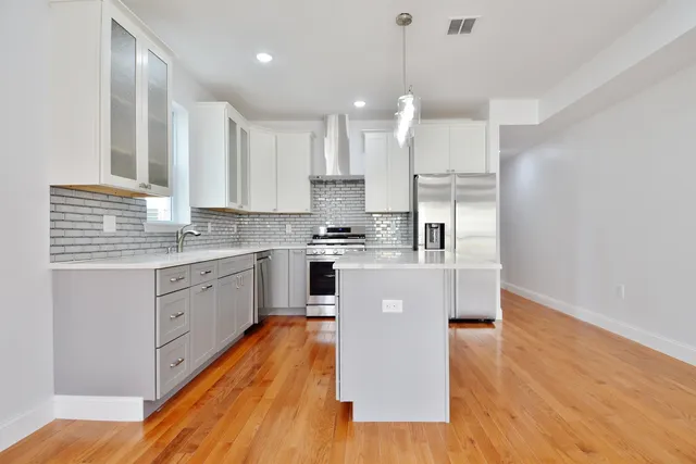 a stove top oven sitting inside of a kitchen