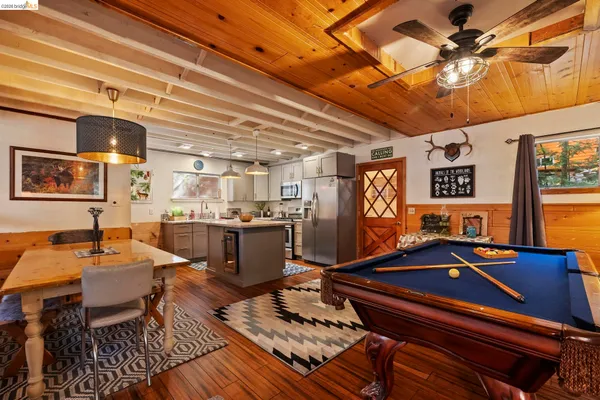 a room with furniture pool table and windows