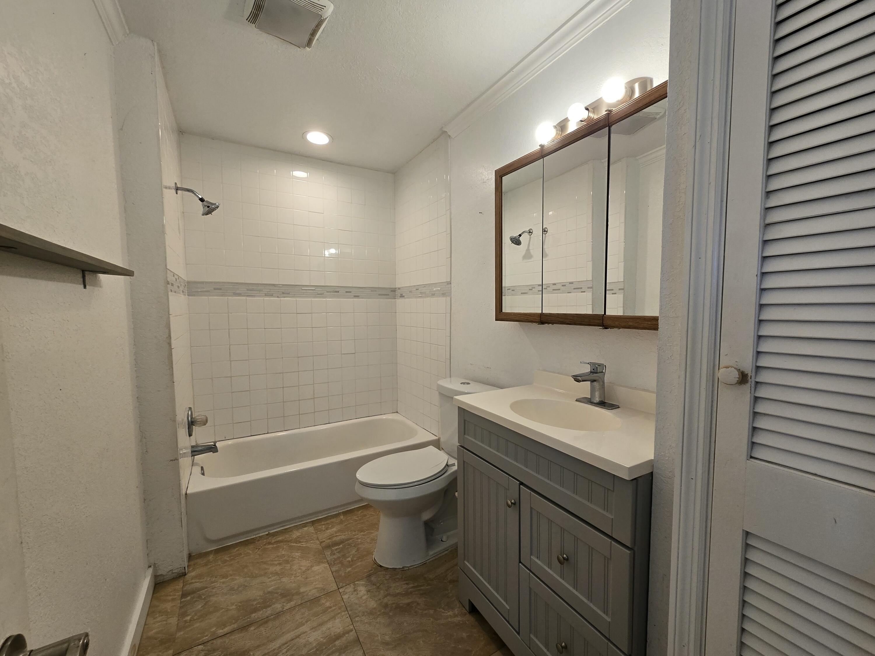 820 Southwest Palm City Road Stuart, FL 34994 - Photo 15 of 24 a bathroom with a sink toilet and shower