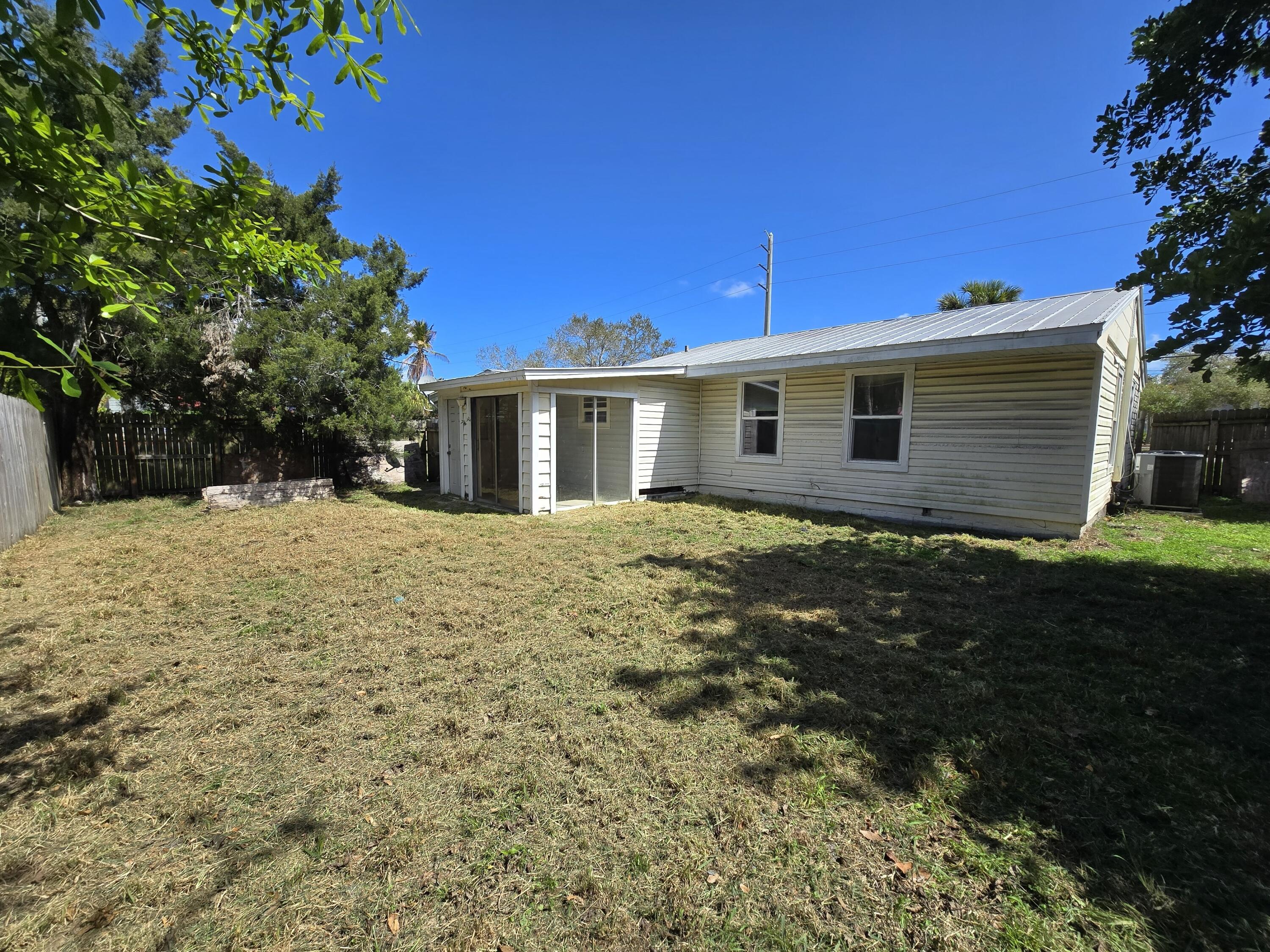 820 Southwest Palm City Road Stuart, FL 34994 - Photo 22 of 24 a front view of a house with a yard