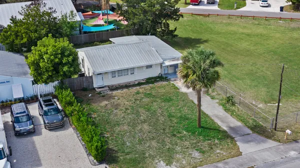 an aerial view of a house with garden space and street view