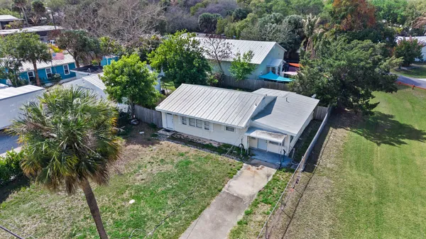 an aerial view of a house with garden space and street view