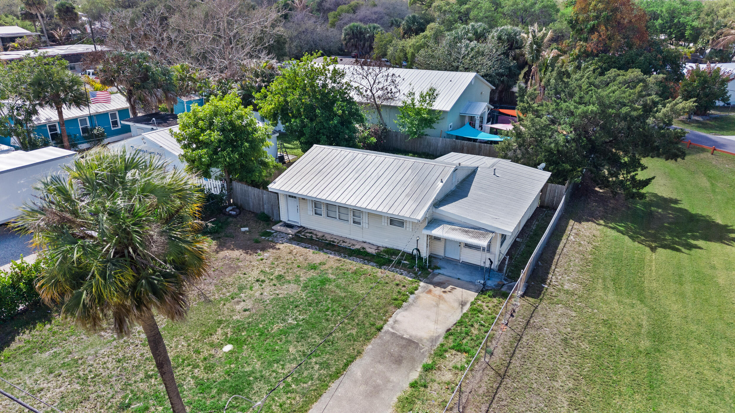 820 Southwest Palm City Road Stuart, FL 34994 - Photo 6 of 24 an aerial view of a house with garden space and street view