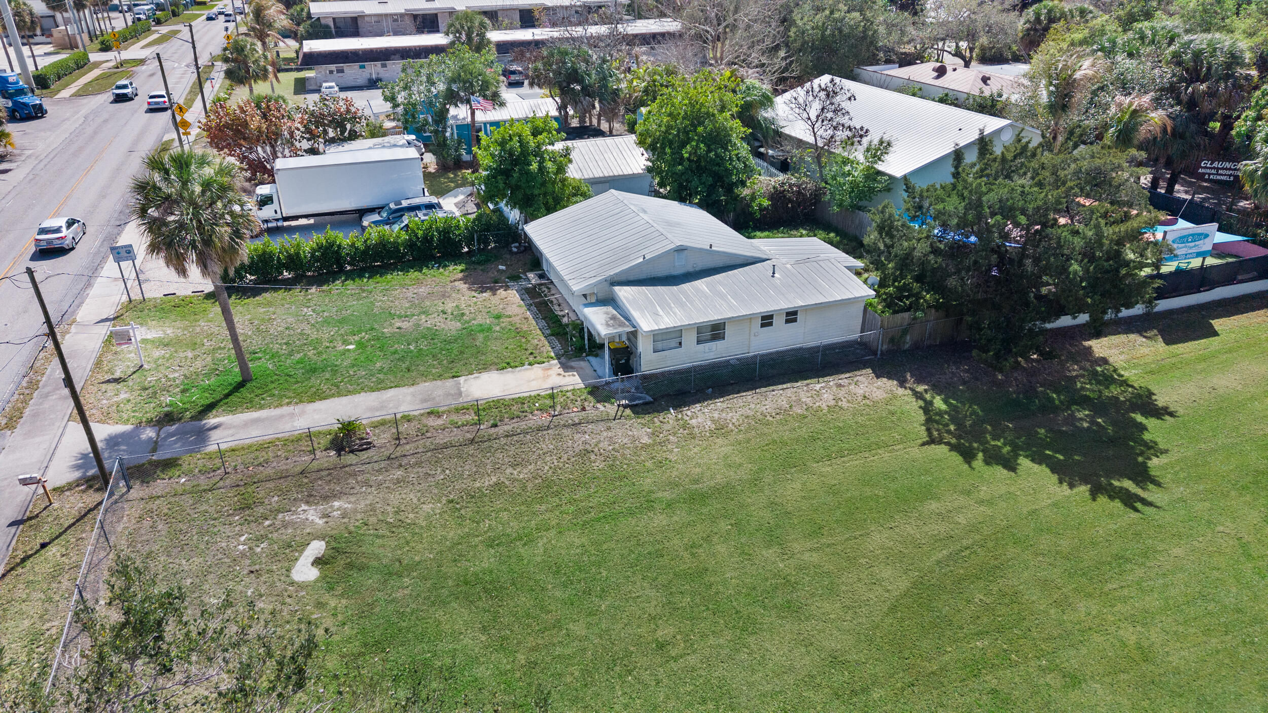 820 Southwest Palm City Road Stuart, FL 34994 - Photo 7 of 24 an aerial view of a house with garden space and street view