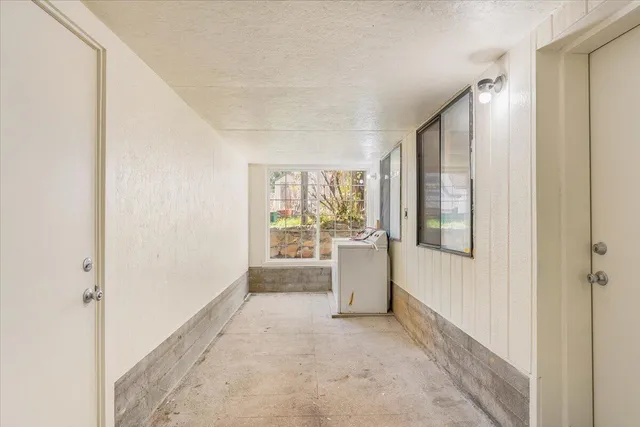 a view of a room with window and front door