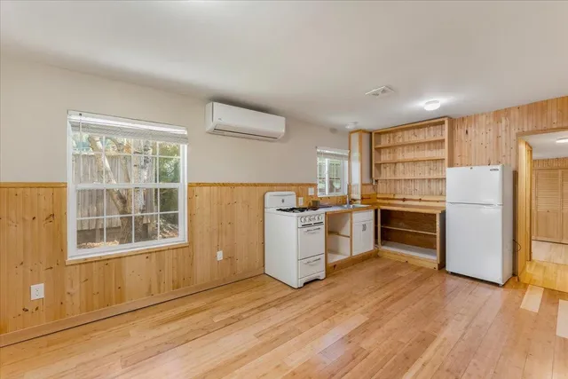 a kitchen with a refrigerator and a stove top oven