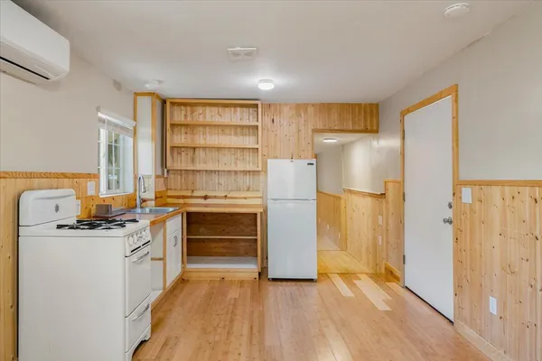 a kitchen with stainless steel appliances a stove a refrigerator and a refrigerator