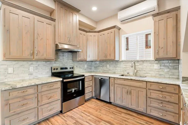 a kitchen with white cabinets sink and stainless steel appliances