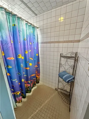 a bathroom with a toilet a sink a light fixture and mirror
