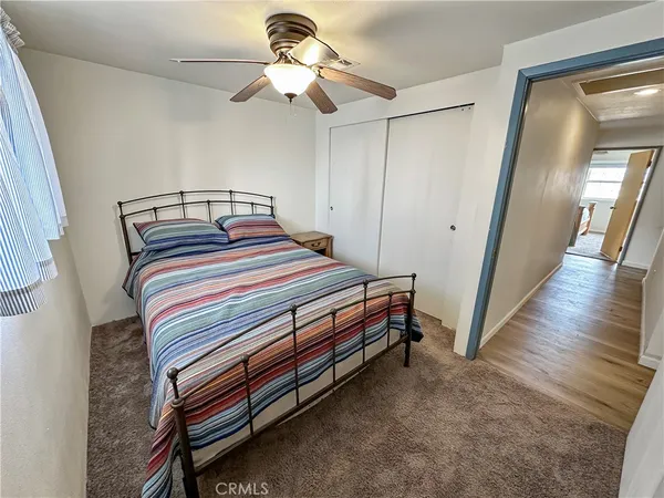 a bedroom with a bed next to a window