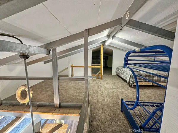 a bed room with a bed and a chair