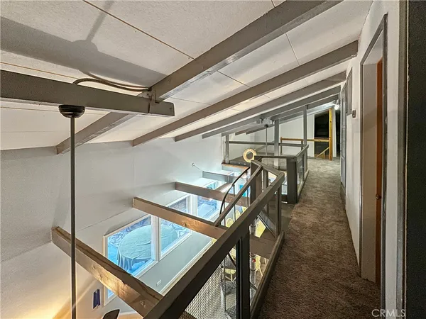 a bedroom with a bed chair and the view of living room