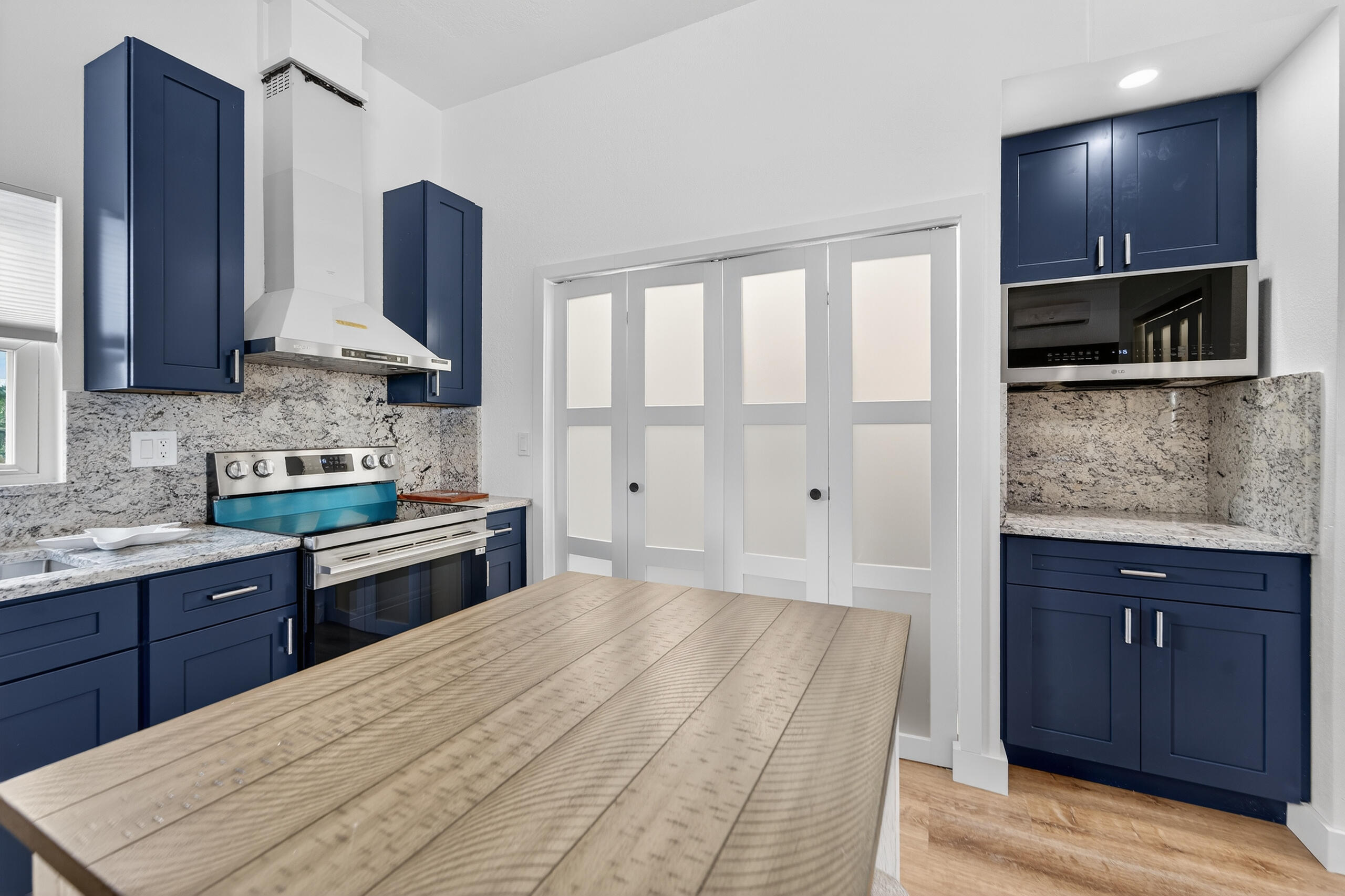300 East 24th Street Riviera Beach, FL 33404 - Photo 4 of 19 a kitchen with a sink stove and microwave
