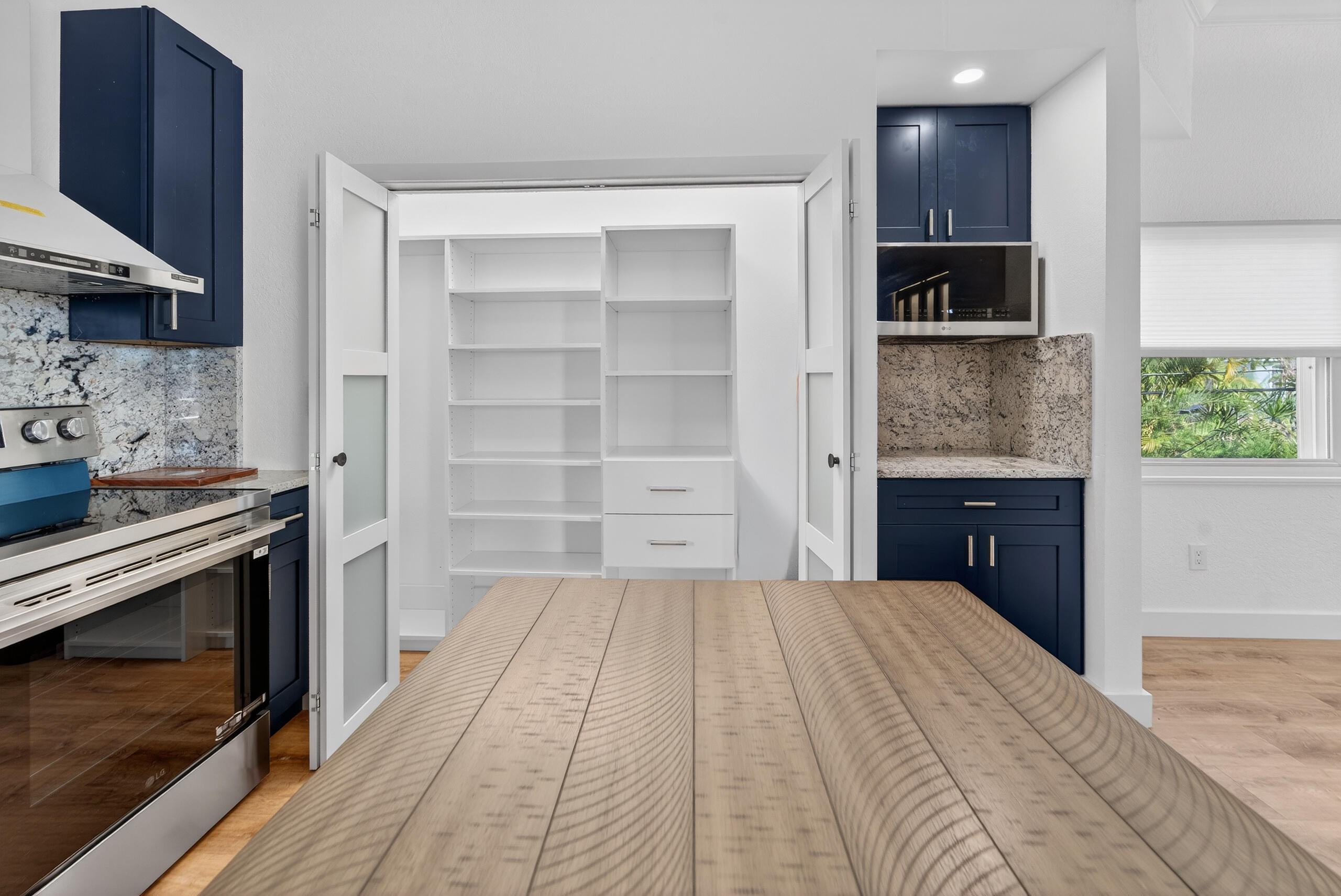 300 East 24th Street Riviera Beach, FL 33404 - Photo 5 of 19 a kitchen with a stove and a refrigerator