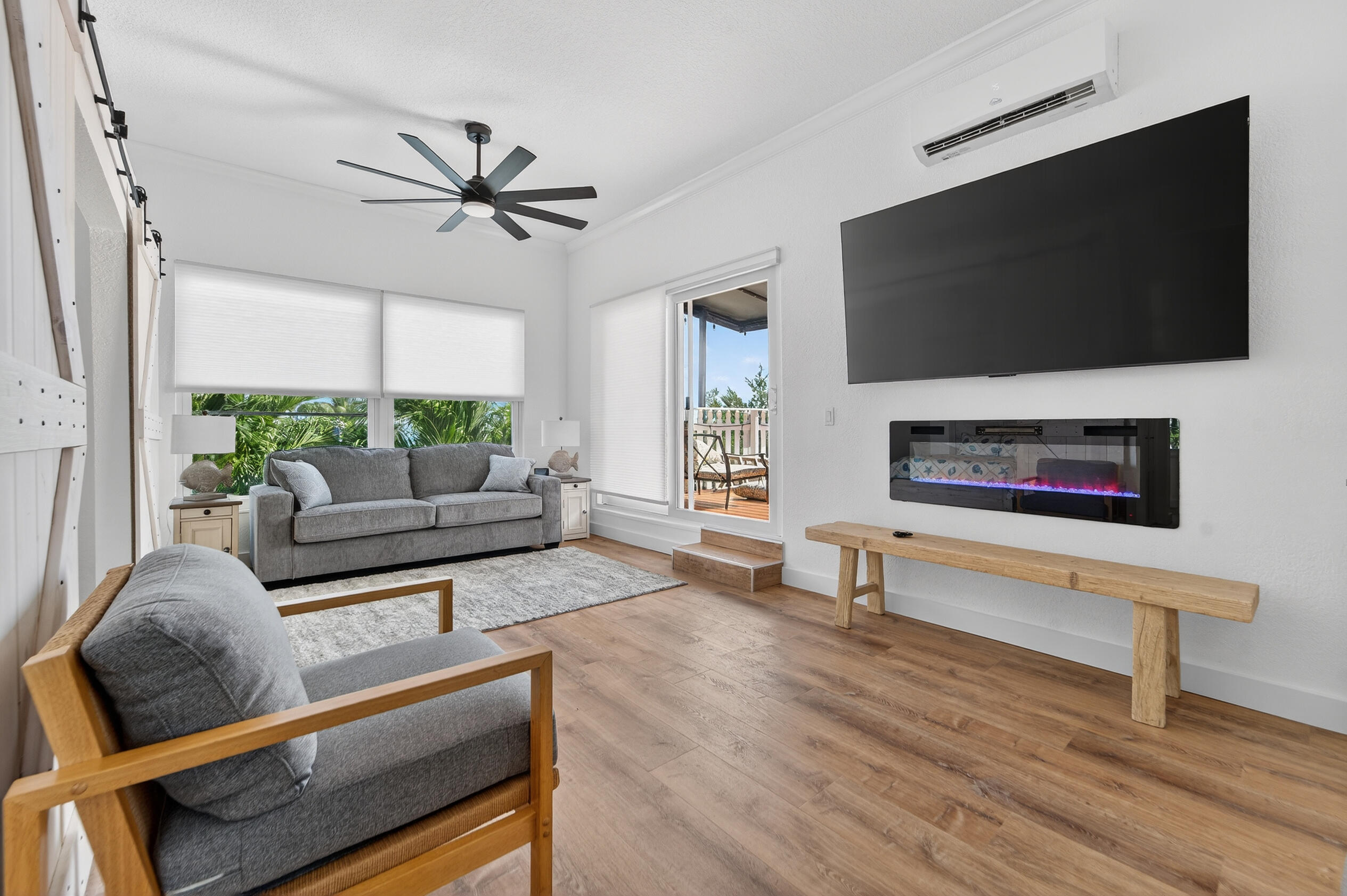 300 East 24th Street Riviera Beach, FL 33404 - Photo 10 of 19 a living room with furniture and a flat screen tv