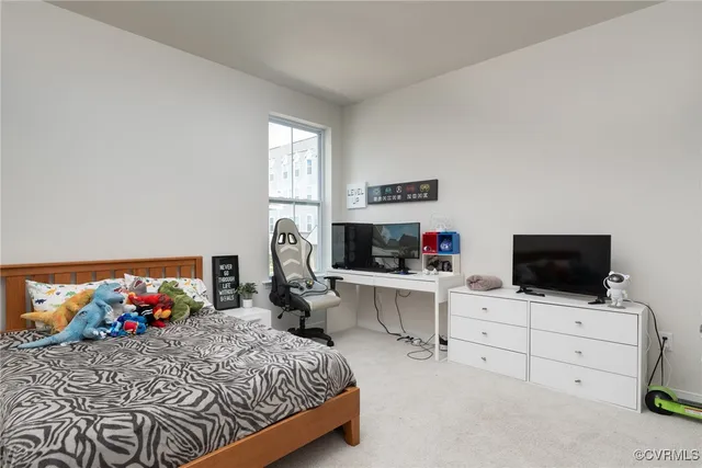 a bedroom with a bed and flat screen tv