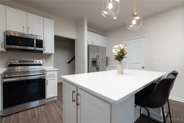 a kitchen with a stove a microwave and a refrigerator