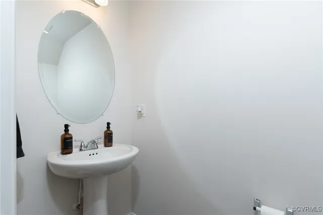 a bathroom with a sink and mirror