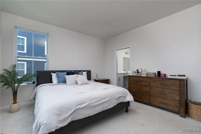a bedroom with a bed and a potted plant