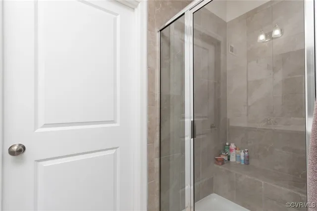 a bathroom with a shower and a mirror