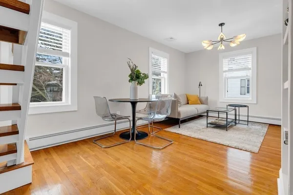 a living room with furniture window and wooden floor