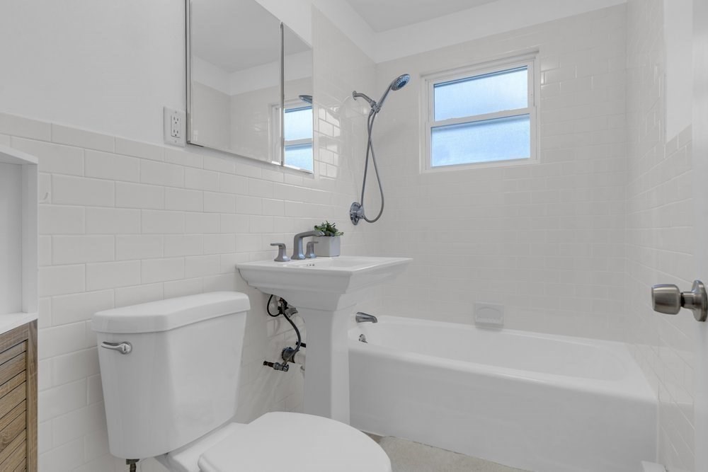35 Boulevard Road, Unit 35 Arlington, MA 02474 - Photo 12 of 20 a white bath tub sitting next to a white toilet and sink