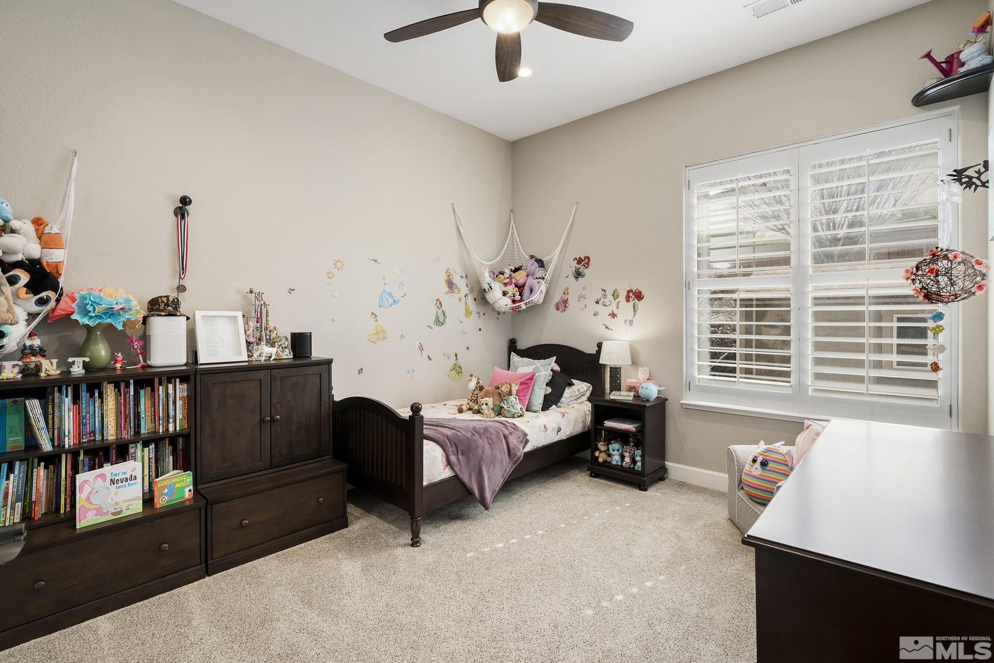 5630 North White Sands Road Reno, NV 89511 - Photo 19 of 40 a bedroom with furniture and a window