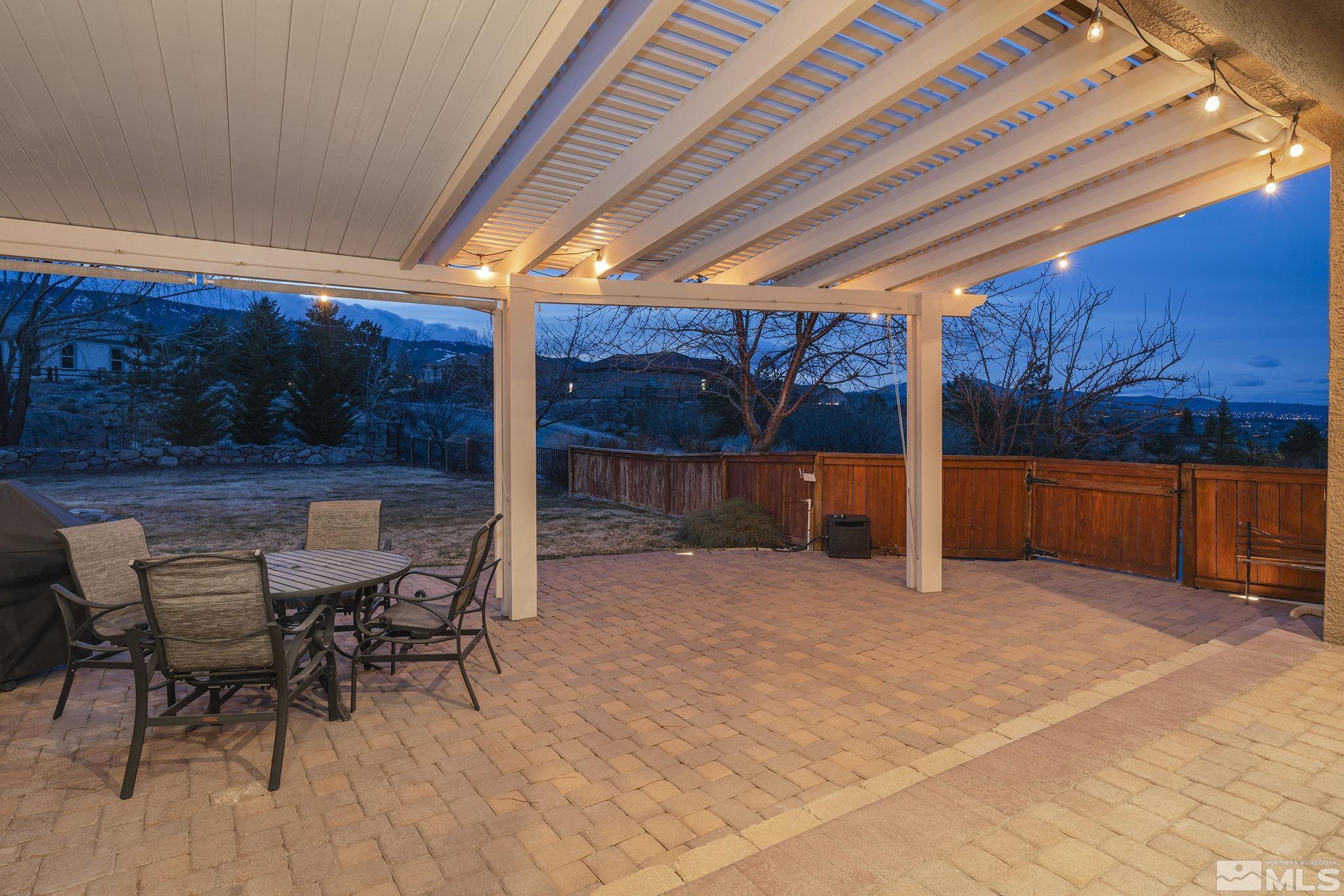 5630 North White Sands Road Reno, NV 89511 - Photo 23 of 40 a view of a patio with table and chairs under an umbrella with a patio